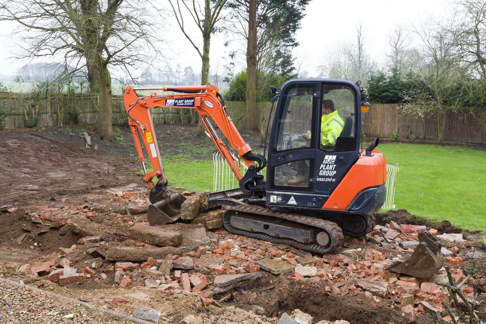 A Sand Stone Paving crew compacting a base before laying asphalt
